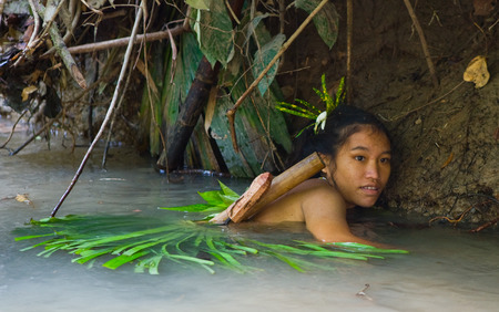 MENTAWAI PEOPLE, WEST SUMATRA, SIBERUT ISLAND, INDONESIA - 16 NOVEMBER 2010: Women Mentawai tribe fishing.のeditorial素材