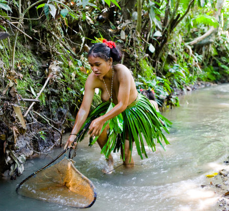 MENTAWAI PEOPLE, WEST SUMATRA, SIBERUT ISLAND, INDONESIA - 16 NOVEMBER 2010: Women Mentawai tribe fishing.のeditorial素材