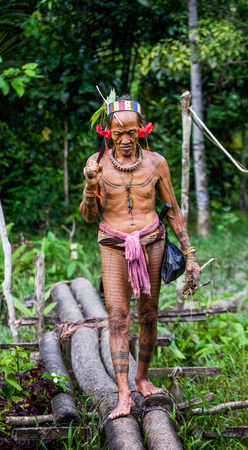 MENTAWAI PEOPLE, WEST SUMATRA, SIBERUT ISLAND, INDONESIA - 03 OKTOBER 2011: Man Mentawai tribe comes back home from hunting.のeditorial素材