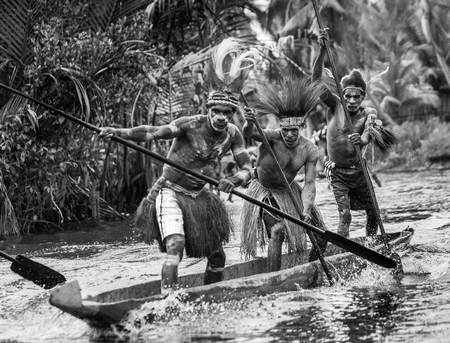 INDONESIA, IRIAN JAYA, ASMAT PROVINCE, JOW VILLAGE - JUNE 12: Warriors Asmat tribe are use traditional canoe.のeditorial素材