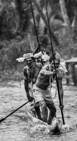 INDONESIA, IRIAN JAYA, ASMAT PROVINCE, JOW VILLAGE - JUNE 12: Warriors Asmat tribe are use traditional canoe.のeditorial素材