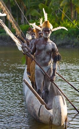 INDONESIA, IRIAN JAYA, ASMAT PROVINCE, JOW VILLAGE - JUNE 12: Warriors Asmat tribe are use traditional canoe.のeditorial素材
