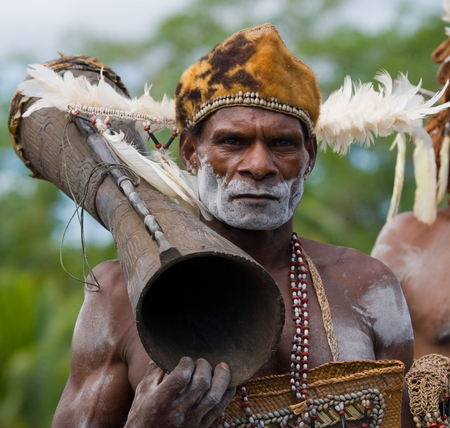 INDONESIA, IRIAN JAYA, ASMAT PROVINCE, JOW VILLAGE - JUNE 12: Portrait of a Warrior Asmat tribe with a ritual drum.のeditorial素材