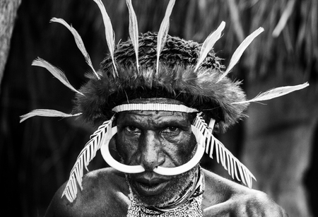 DANI VILLAGE, WAMENA, IRIAN JAYA, NEW GUINEA, INDONESIA - 15 MAY 2012: Portrait of Dani tribe in a beautiful headdress made of feathers.のeditorial素材
