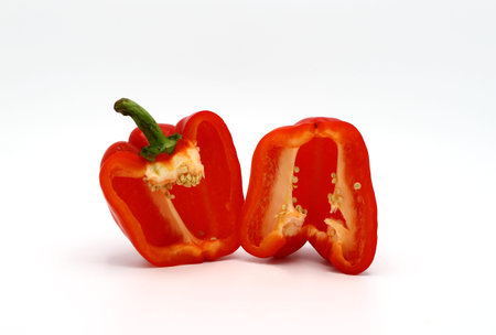 Two halves of red ripe sweet pepper on a light background. Natural product. Natural color. Close-up.