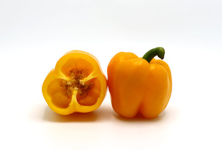 Sweet yellow pepper whole and in a cut on a light background. Natural product. Natural color....