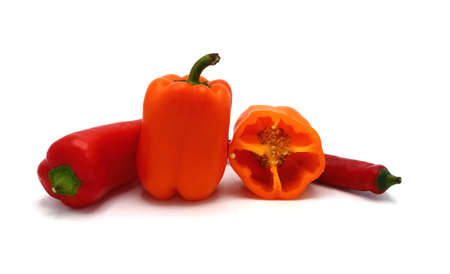 Two red and two orange ripe sweet peppers on a light background. Natural product. Natural color. Close-up.の写真素材