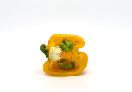 Sweet pepper yellow in cross-section on a light background. Natural product. Natural color....