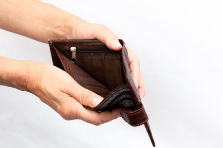 In the hands of an empty wallet. close-up. white background. Poverty concept