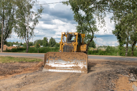 Crawler bulldozer clears the ground with a metal shield. road construction works. Landscaping....