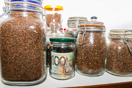 Belarusian paper money in a glass jar among other jars with cereals and dried fruits. Keeping money in a glass jar. Money saving concept. Secret piggy bank. Keeping cash at home. financial reserves.の写真素材