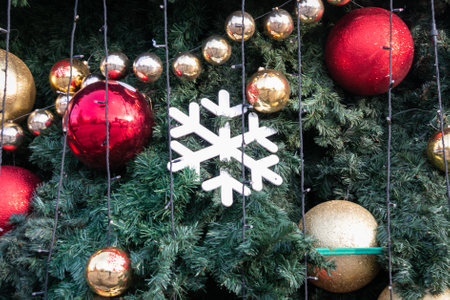 New Year's toys on the Christmas tree. Balls and snowflakes close-up. Christmas decorations. Festive Christmas toys.の写真素材