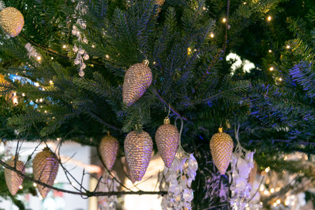 A lot of Christmas cones on the tree. Christmas decorations. Festive Christmas toys. close-up.の写真素材