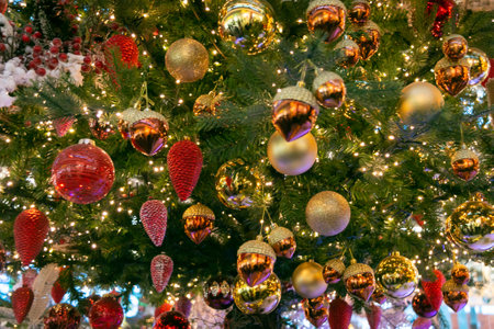 A lot of golden Christmas balls, acorns and Christmas cones on the Christmas tree. Festive Christmas toys. Christmas decorations. close-up.の写真素材