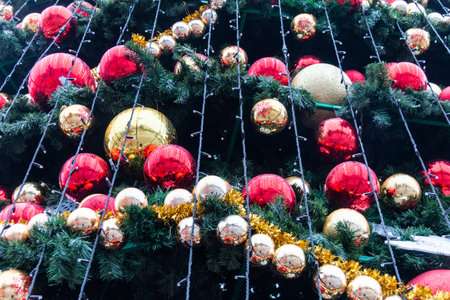 Fragment of a Christmas tree with toys close-up. Christmas balls, toys and decorations hang on the tree.の写真素材