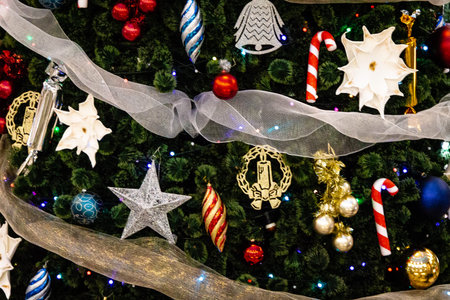 Many different christmas toys hanging on the christmas tree. Christmas and New Year.
