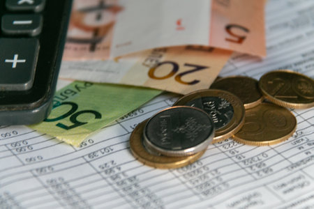 Calculator, Belarusian money, and a receipt for payment of utility bills in Belarus. The concept of paying bills and increasing prices. close-up. Selective focus, narrow focus. Blurred background.の写真素材