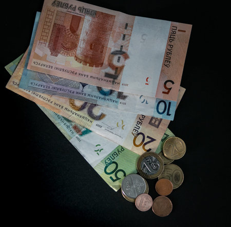 Money banknotes and coins of the Republic of Belarus on a black background. Belarusian currency....
