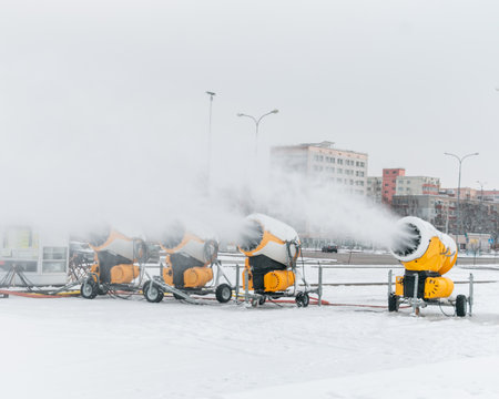 Snow cannons spray artificial snow crystals. Production of artificial snow. snow guns. Cars make snow.の写真素材