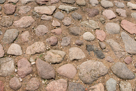 Cobblestone road in the sand. Fragment of paving stones. Background.Texture.の写真素材