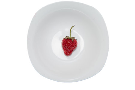 Fresh ripe strawberries in a white plate. Beautiful and tasty strawberries. Dessert. Diet.の写真素材