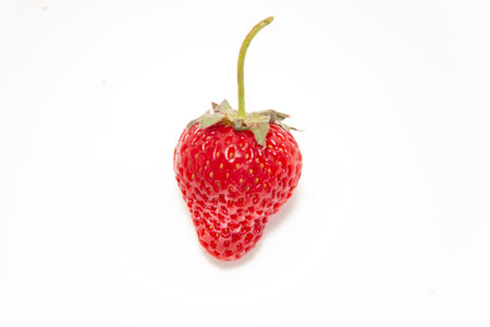 Fresh ripe strawberries with ponytail isolated on white background. Beautiful and tasty strawberries. Dessert.の写真素材