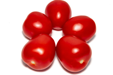 Five red ripe tomatoes in front of white background. close-up. Beautiful red ripe tomatoes.の写真素材