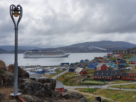 View from one of the many hills of Qaqortog, Iceland, towards the colorful houses of the city, to...
