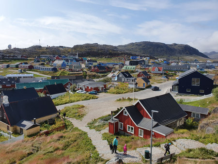 View from one of the many hills of Qaqortog, Iceland, towards the colorful houses of the city
