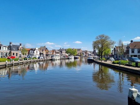 The wide canal running through (Dutch) Lemmer (Frisian) De Lemmer (port town on the IJsselmeer, a very big lake), Friesland, Netherlands, is popular with leisure boaters and tourists alike, with numerous restaurants and shops on both sidesのeditorial素材