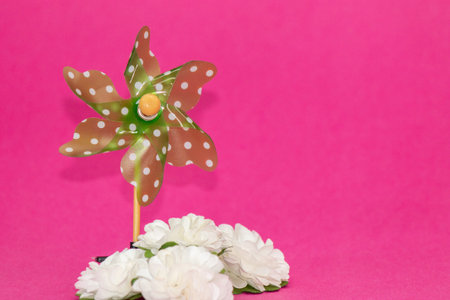 windmill with white flowers on pink backgroundの写真素材