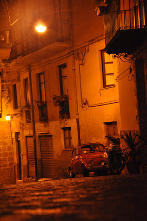 Little Italian Car in a little cobbled street of Sicilyの写真素材