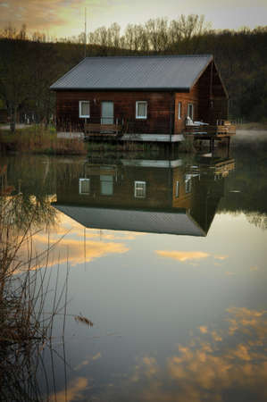 Little Wooden Cabin on Lake in Dordogne at Sunsetのeditorial素材