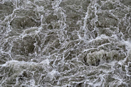 Rippled water with waves and foamの写真素材