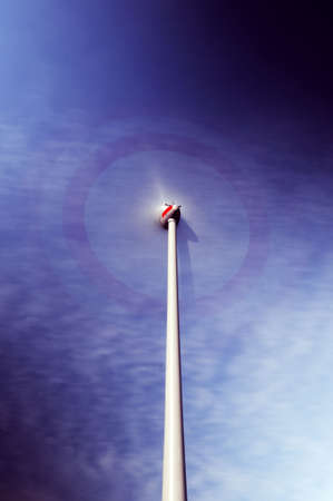 Wind turbine - Rotating wind turbine under a blue skyの写真素材