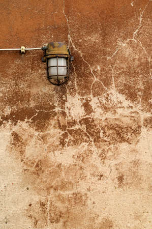 Old Plaster -  Old lamp at an eroded plastered wall の写真素材