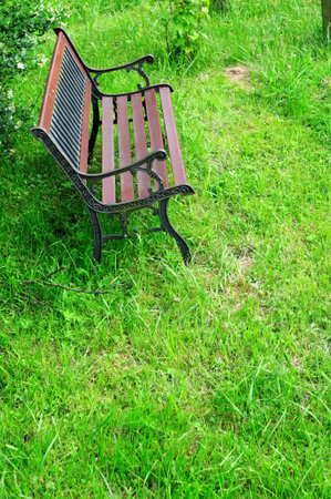Park bench - Brown bench in a public park in sunshineの写真素材