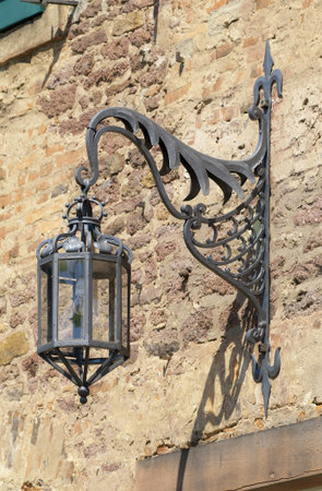 Old arc lamp Old arc lamp fastened at a russet sandstone wall 