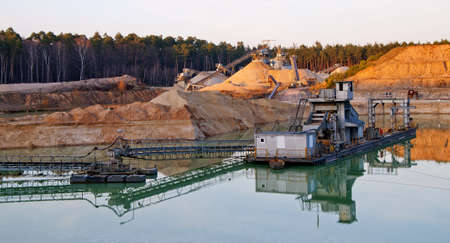 A gravel pit in the forest in sunshineの写真素材