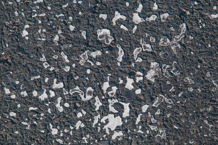 Old Road asphalt texture with relics of white paintの写真素材