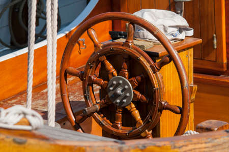 Single wooden steering wheel at an ancient sailing boatの写真素材