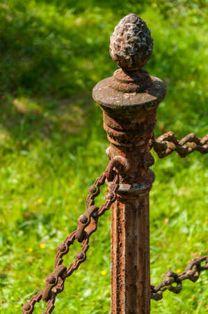 forged rusty chain and poleの写真素材