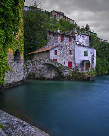 The Ancient Roman bridge in Nesso on Como lake- Italyの写真素材
