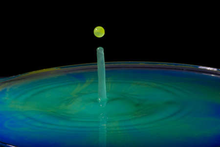 green in blue water splashの写真素材