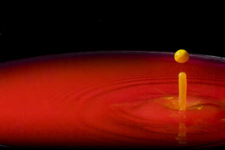 yellow in Red water splashの写真素材