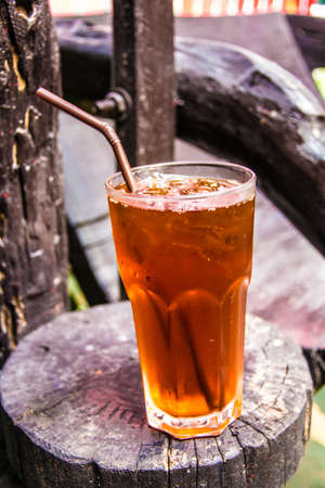Cold iced tea with straws in the back yardの写真素材
