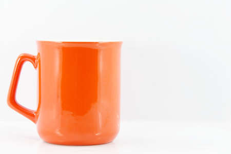 Orange coffee cupの写真素材