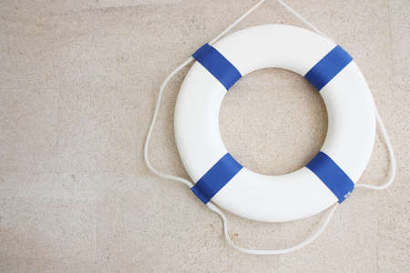 White and blue lifebuoy on  wall の写真素材