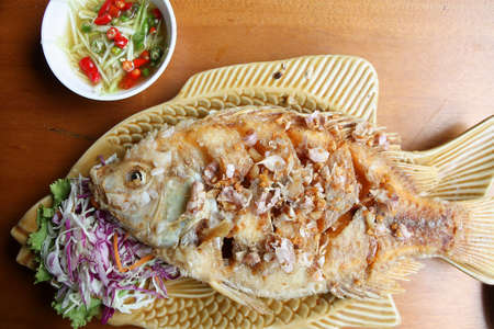 Fried fish with garlic の写真素材
