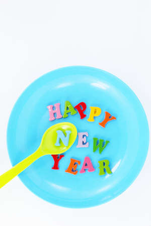 Colorful character Happy New Year greetings in plastic dishes の写真素材